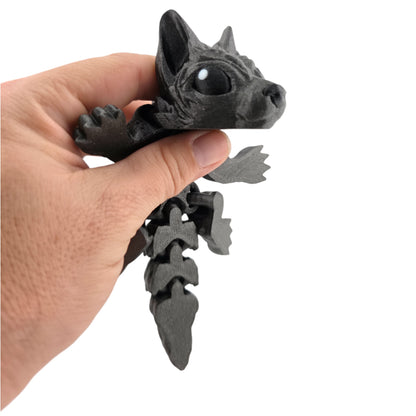 Galaxy Black Tiny Wolf Pup held in hand for scale