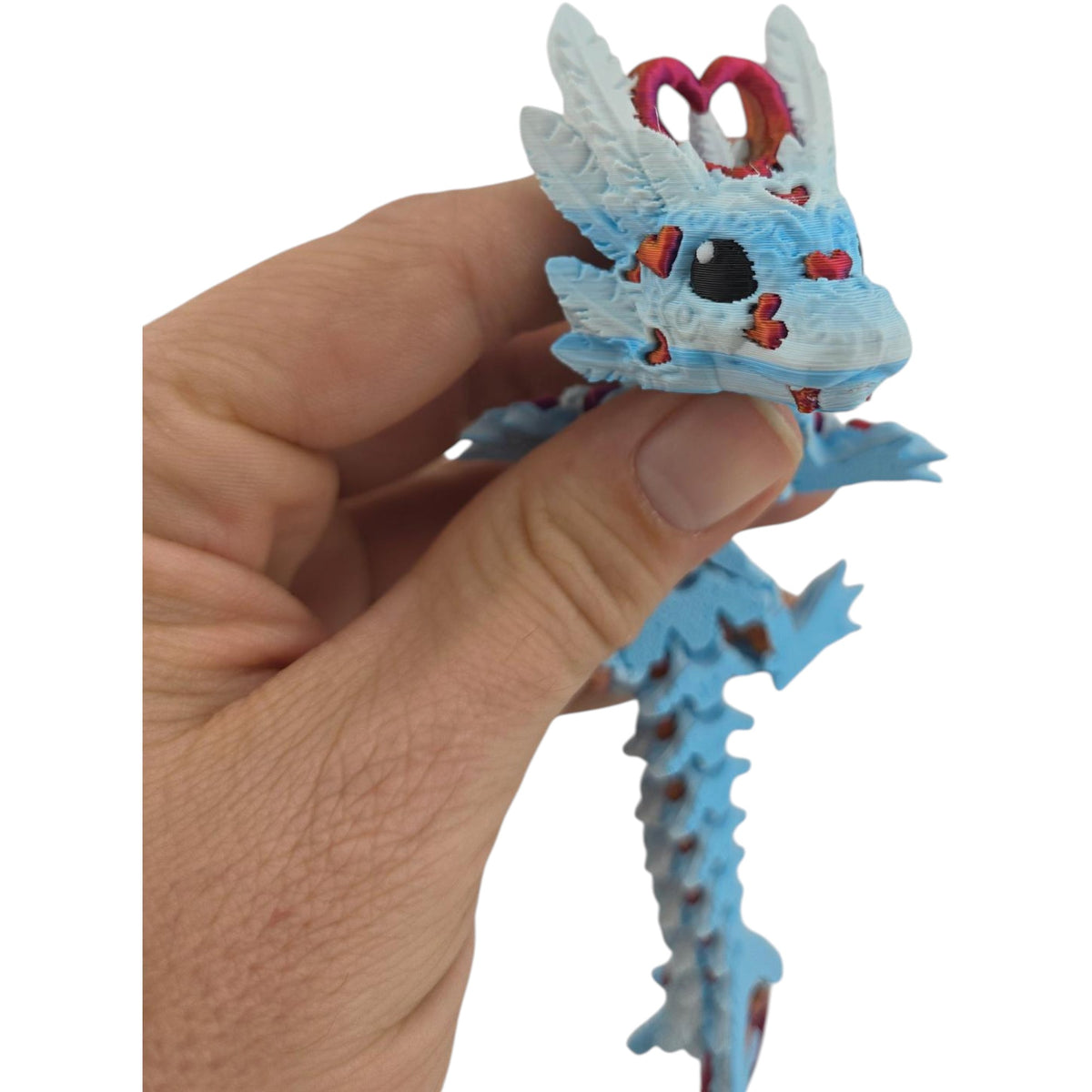 Winter and Silk Red Light Heart Baby Dragon held in hand for scale